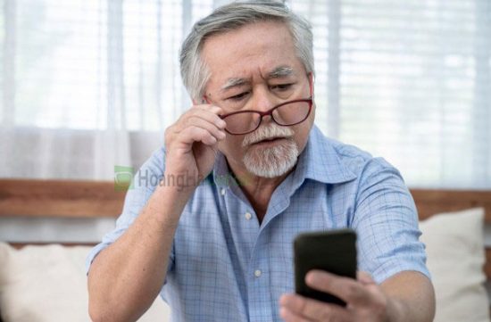 older gentleman struggling to read from phone and lower glasses due to poor near vision resizedimagewzywmcwzotrd